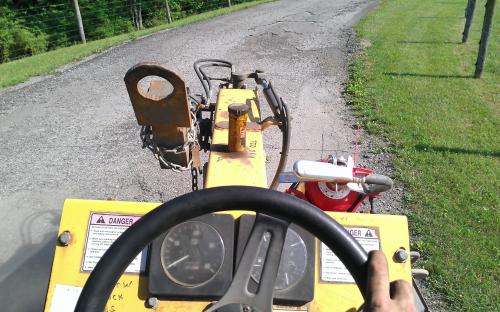 Operating the three wheeled broom to finish out a project.