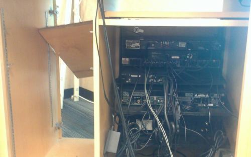 Presentation cabinet pulled apart and a mess from people trying to fix the wiring on their own.