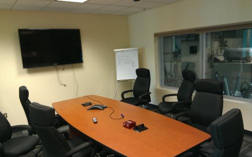 Conference Room 1 Before: Temporary wires run over table. Tabletop hookups broken and not used properly.