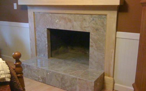 Brick wall removed, new frame and drywall put up, painted and finished. Tiled fireplace with marble and built a custom fireplace mantle, almost complete.