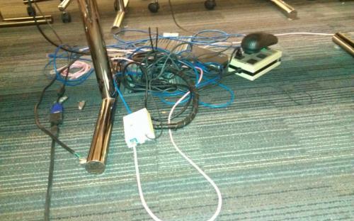 Another conference room before. Equipment damaged and located on floor. Wiring portal also damaged.